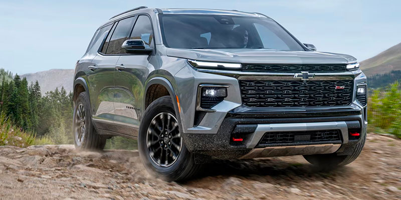 A 2025 Chevrolet Traverse driving on a dirt road